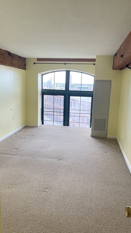 200 Market Street, Unit 505 Lowell, MA 01852 - Photo 19 of 22 a view of an empty room with a window