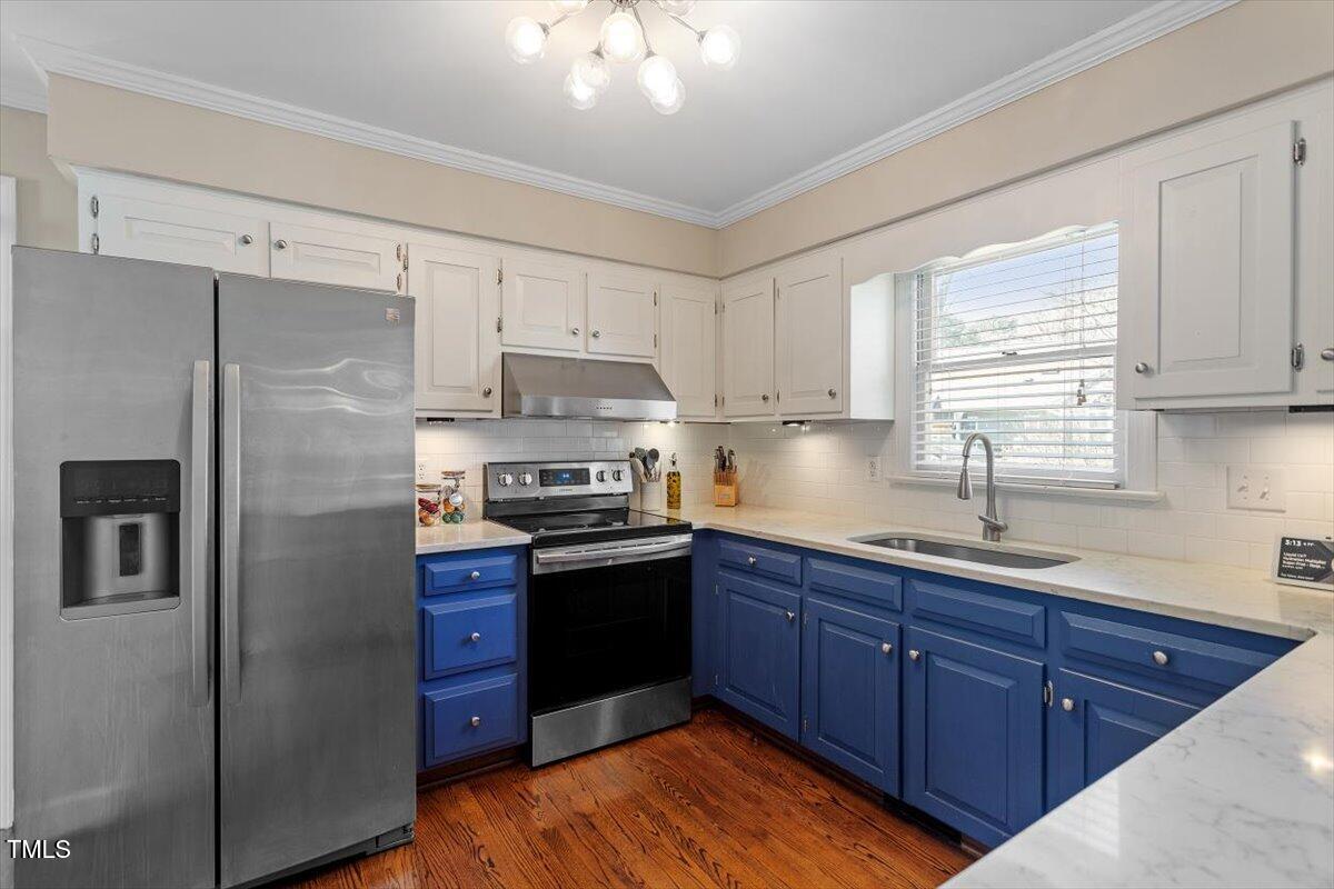 8617 Canoe Court Raleigh, NC 27615 - Photo 12 of 40 a kitchen with stainless steel appliances granite countertop a refrigerator a sink dishwasher a stove with wooden cabinets and floor