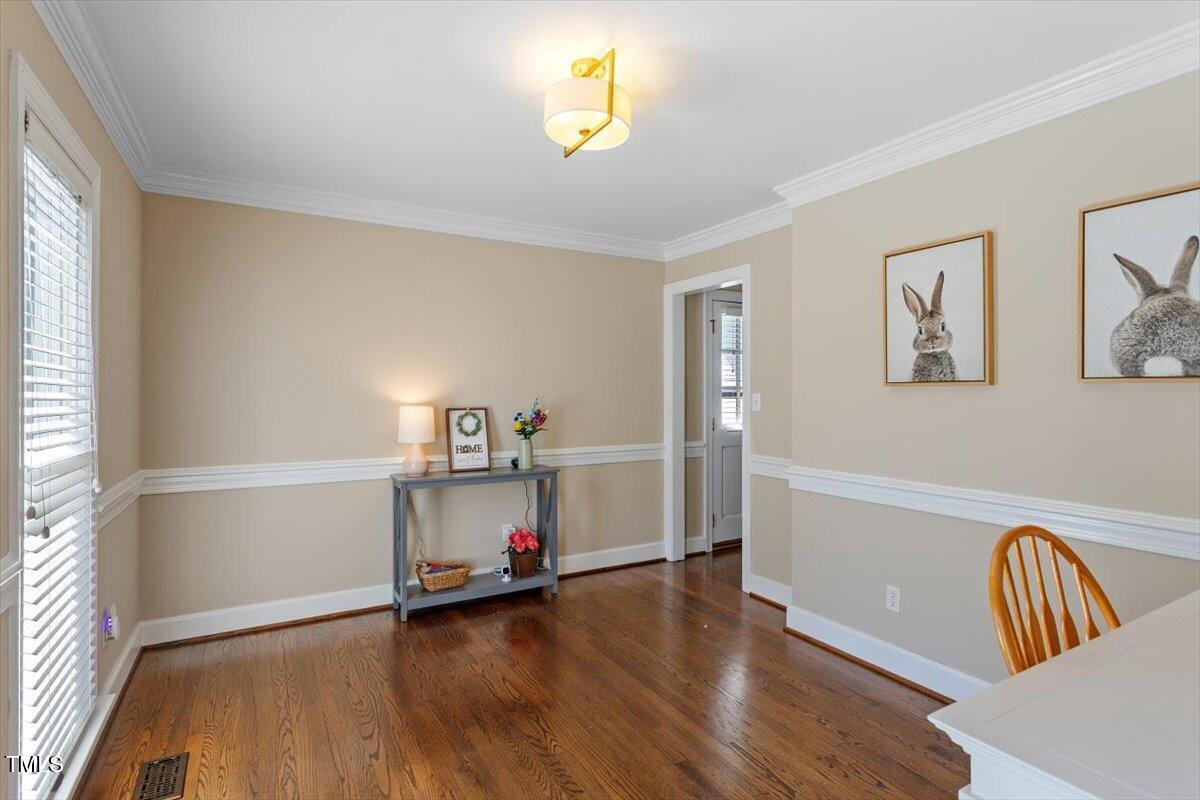 8617 Canoe Court Raleigh, NC 27615 - Photo 16 of 40 a view of room with wooden floor and window
