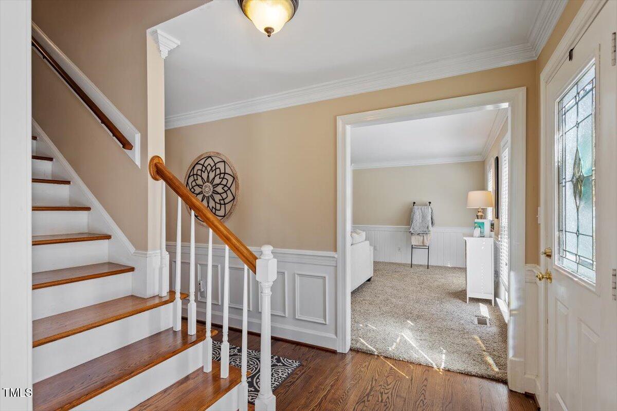 8617 Canoe Court Raleigh, NC 27615 - Photo 18 of 40 a view of a hallway with wooden floor and stairs