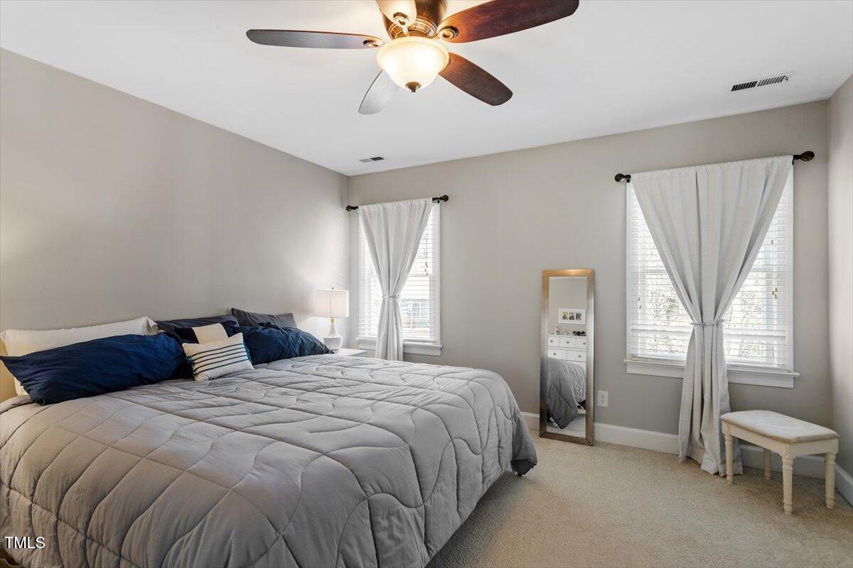 8617 Canoe Court Raleigh, NC 27615 - Photo 20 of 40 a bedroom with a bed and a window