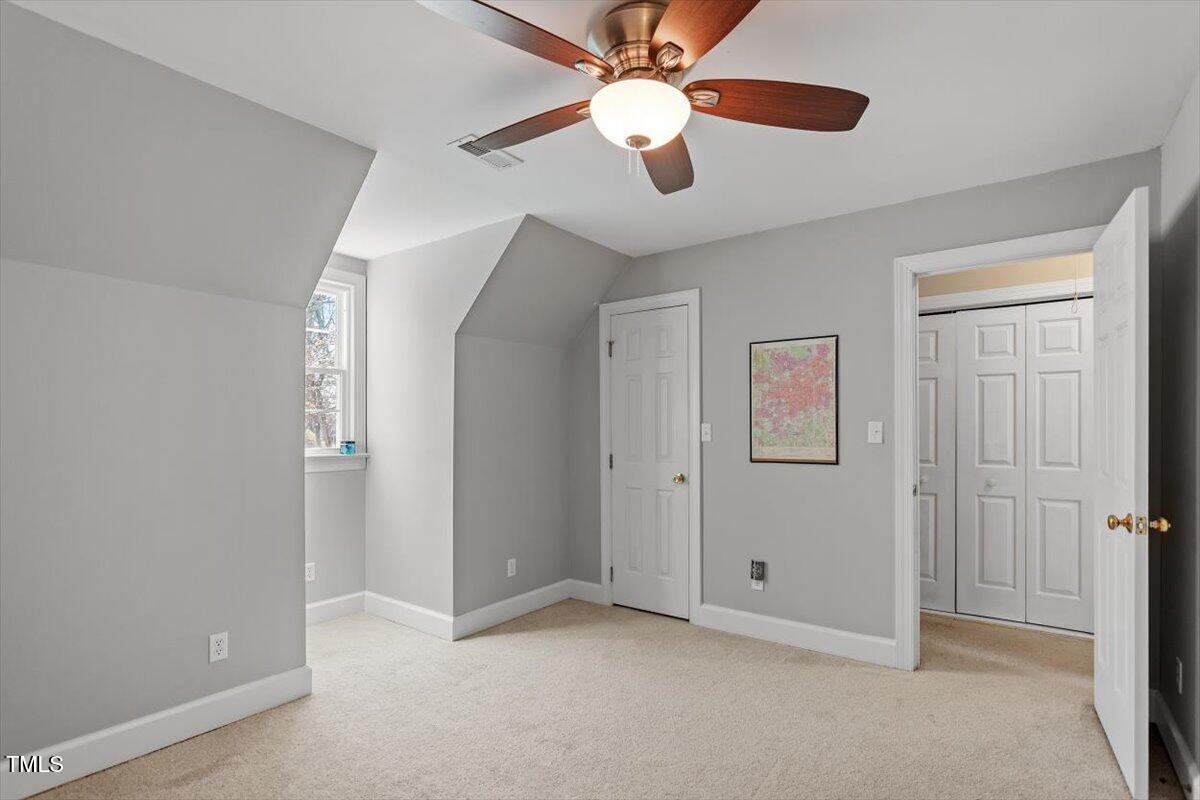 8617 Canoe Court Raleigh, NC 27615 - Photo 26 of 40 an empty room with closet and a chandelier fan