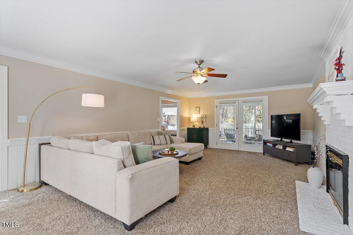 8617 Canoe Court Raleigh, NC 27615 - Photo 3 of 40 a living room with furniture and a flat screen tv