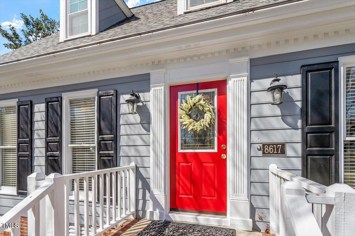 8617 Canoe Court Raleigh, NC 27615 - Photo 8 of 40 a front view of a building with red door and front door