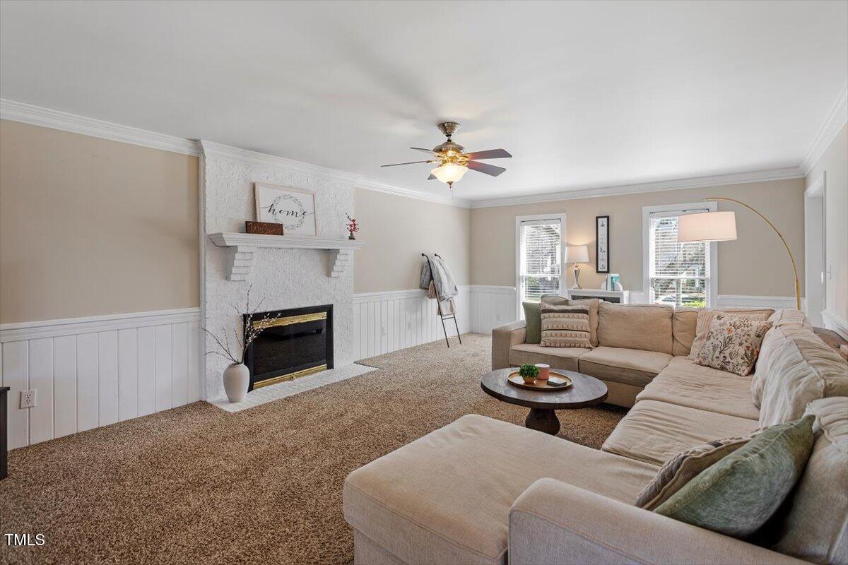 8617 Canoe Court Raleigh, NC 27615 - Photo 10 of 40 a living room with furniture a fireplace and a window