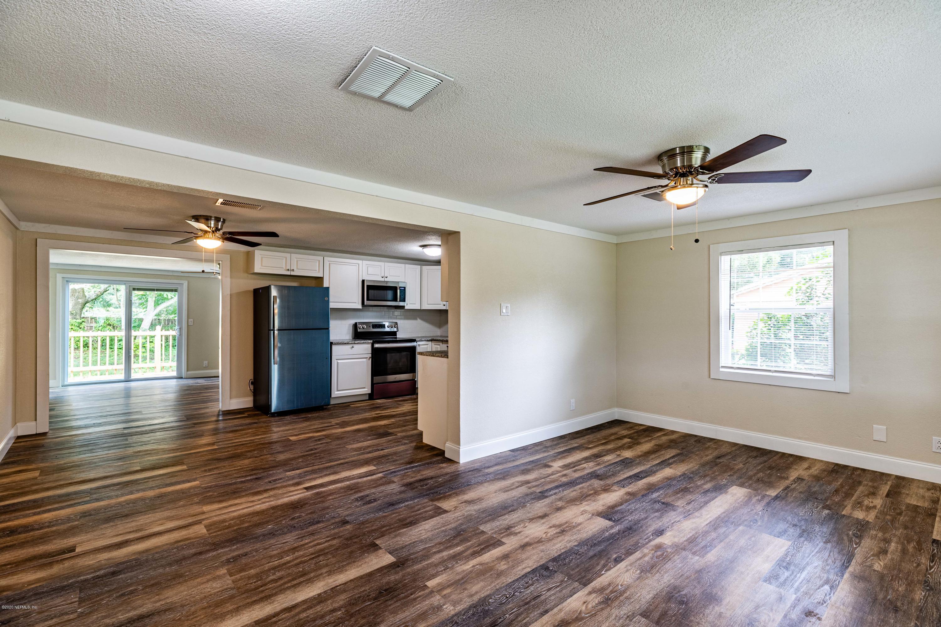 620 Southwest Field Avenue Keystone Heights, FL 32656 - Photo 12 of 68 a view of an empty room with window and wooden floor