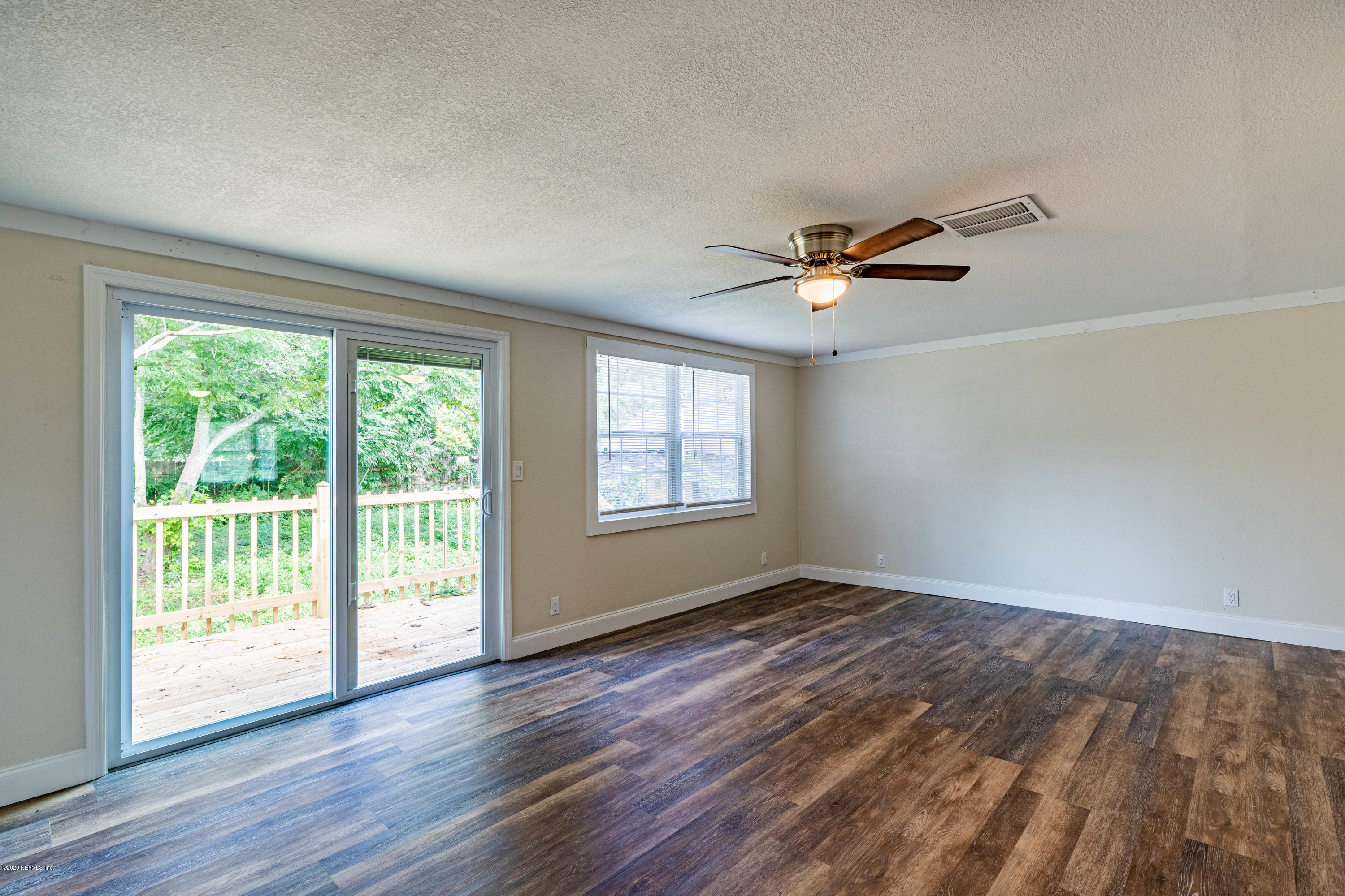620 Southwest Field Avenue Keystone Heights, FL 32656 - Photo 18 of 68 a view of an empty room with wooden floor and a window