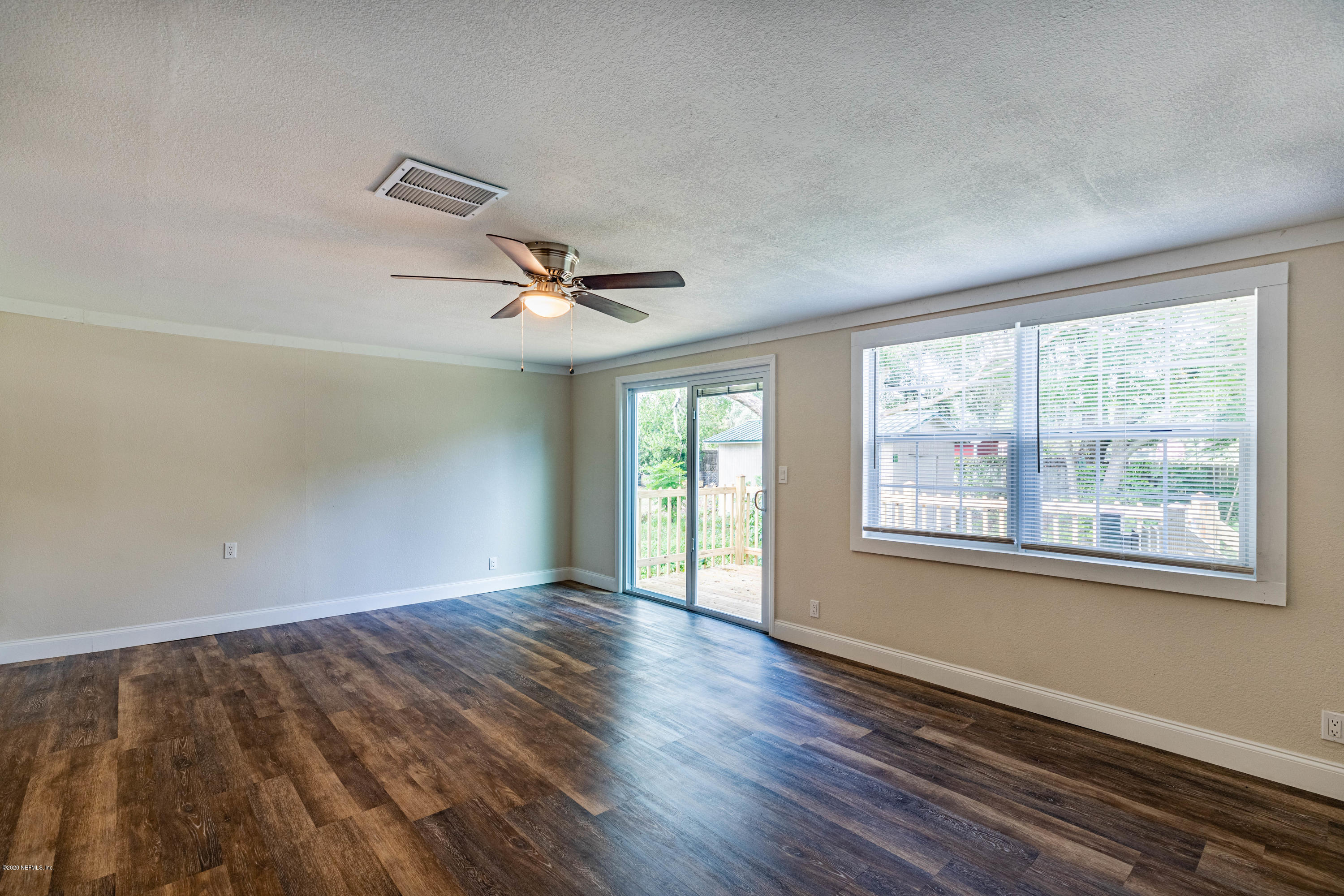 620 Southwest Field Avenue Keystone Heights, FL 32656 - Photo 21 of 68 a view of an empty room with wooden floor and a window