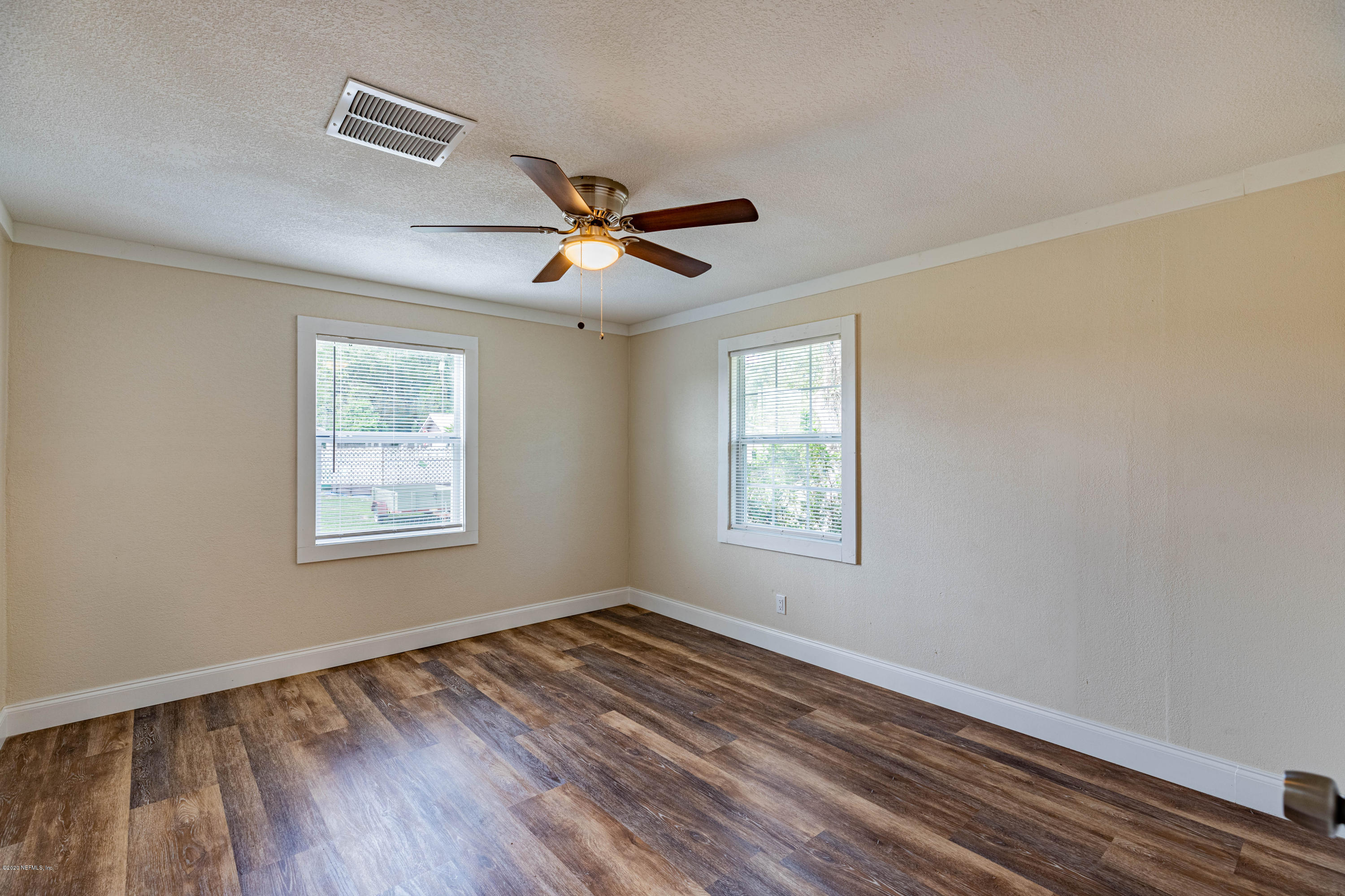 620 Southwest Field Avenue Keystone Heights, FL 32656 - Photo 22 of 68 a view of empty room with wooden floor and fan