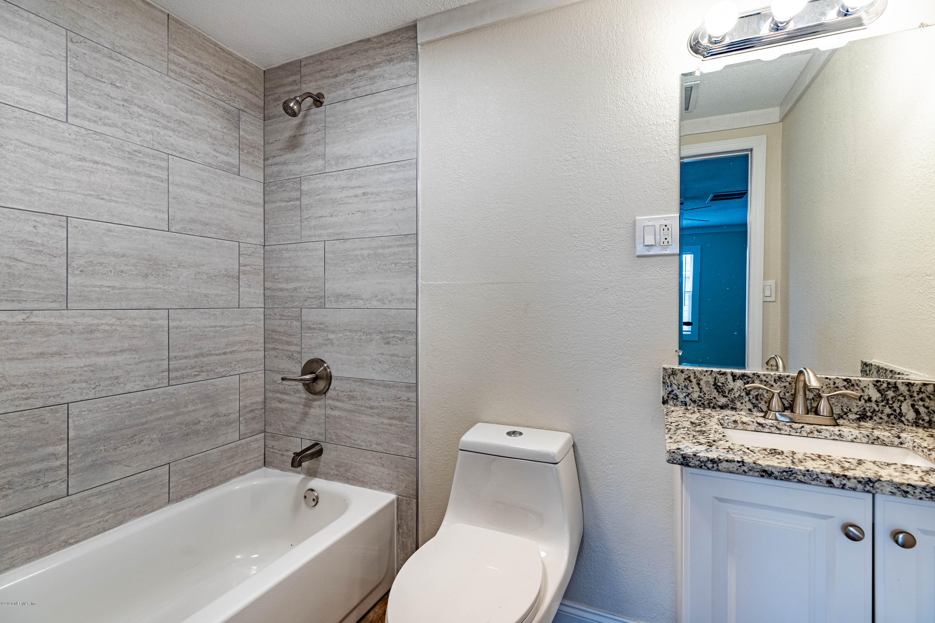 620 Southwest Field Avenue Keystone Heights, FL 32656 - Photo 25 of 68 a bathroom with a granite countertop sink toilet and shower
