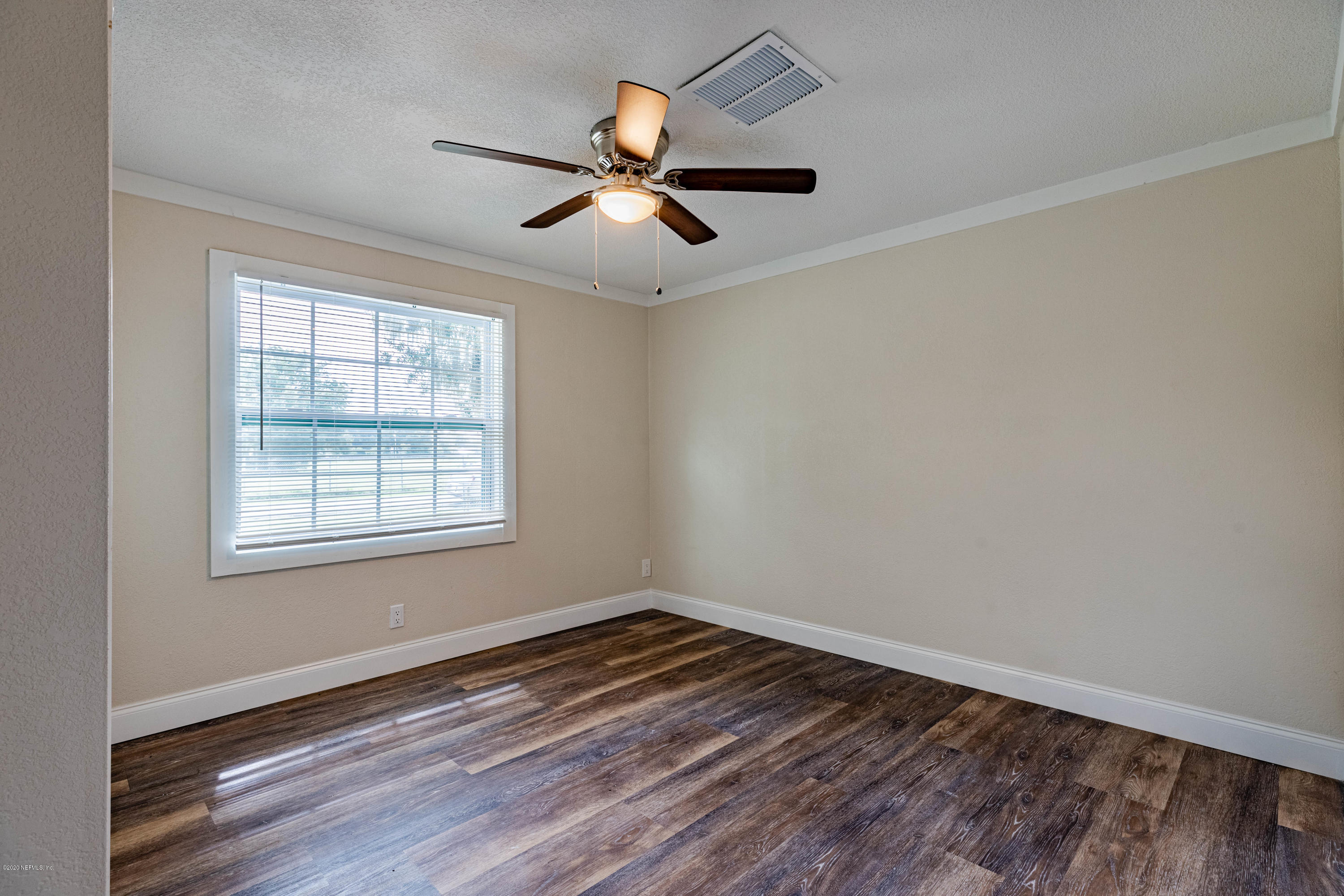 620 Southwest Field Avenue Keystone Heights, FL 32656 - Photo 26 of 68 wooden floor in an empty room with a window
