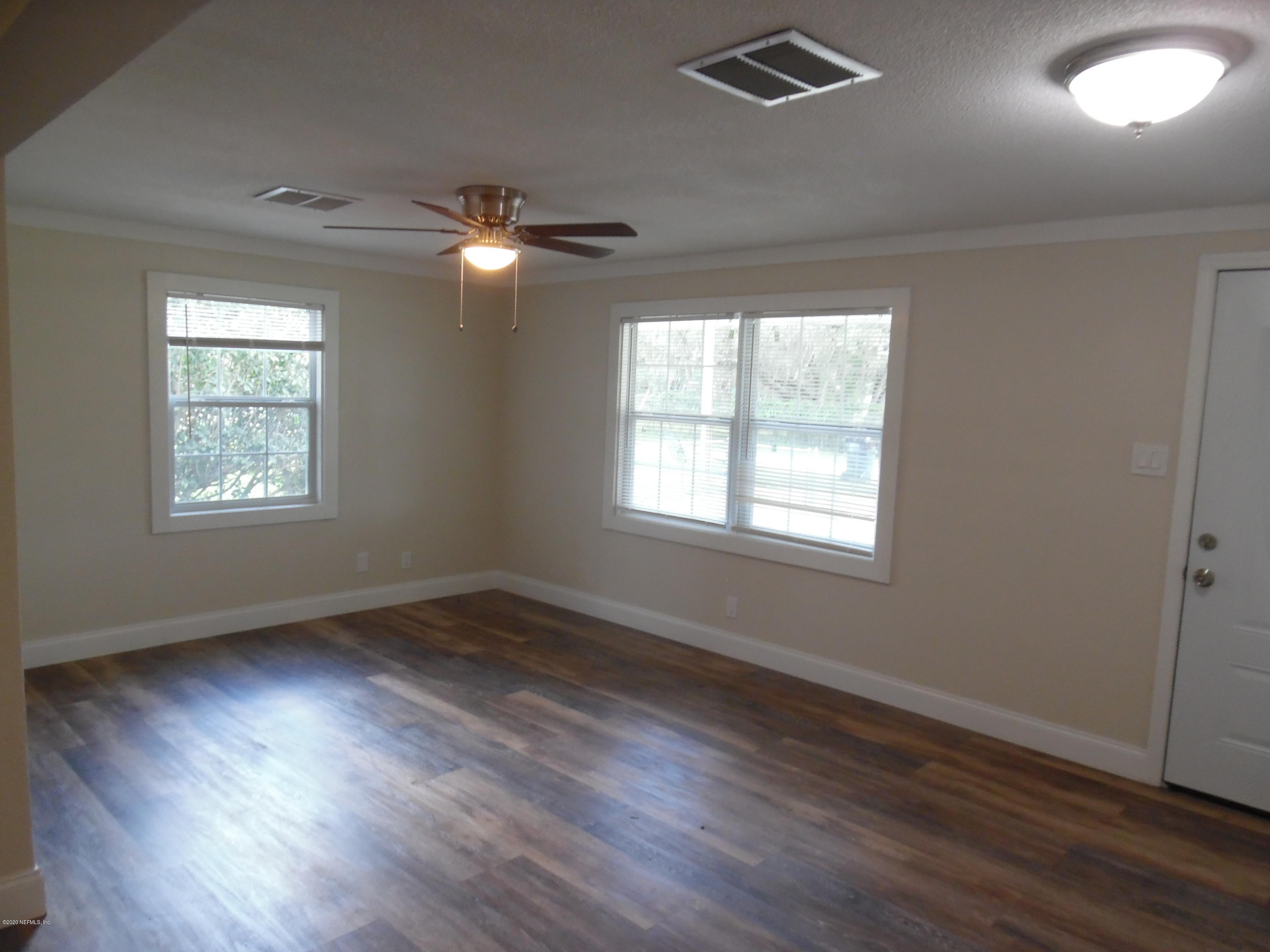 620 Southwest Field Avenue Keystone Heights, FL 32656 - Photo 40 of 68 a view of an empty room with wooden floor and a window