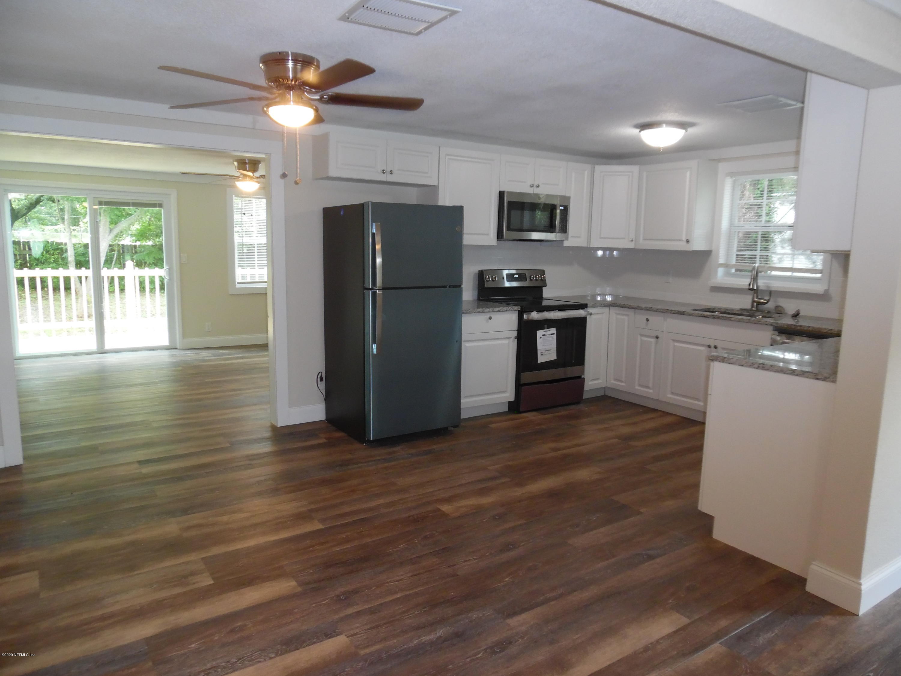 620 Southwest Field Avenue Keystone Heights, FL 32656 - Photo 47 of 68 a kitchen with stainless steel appliances granite countertop a refrigerator a stove a sink dishwasher and a oven with wooden floors