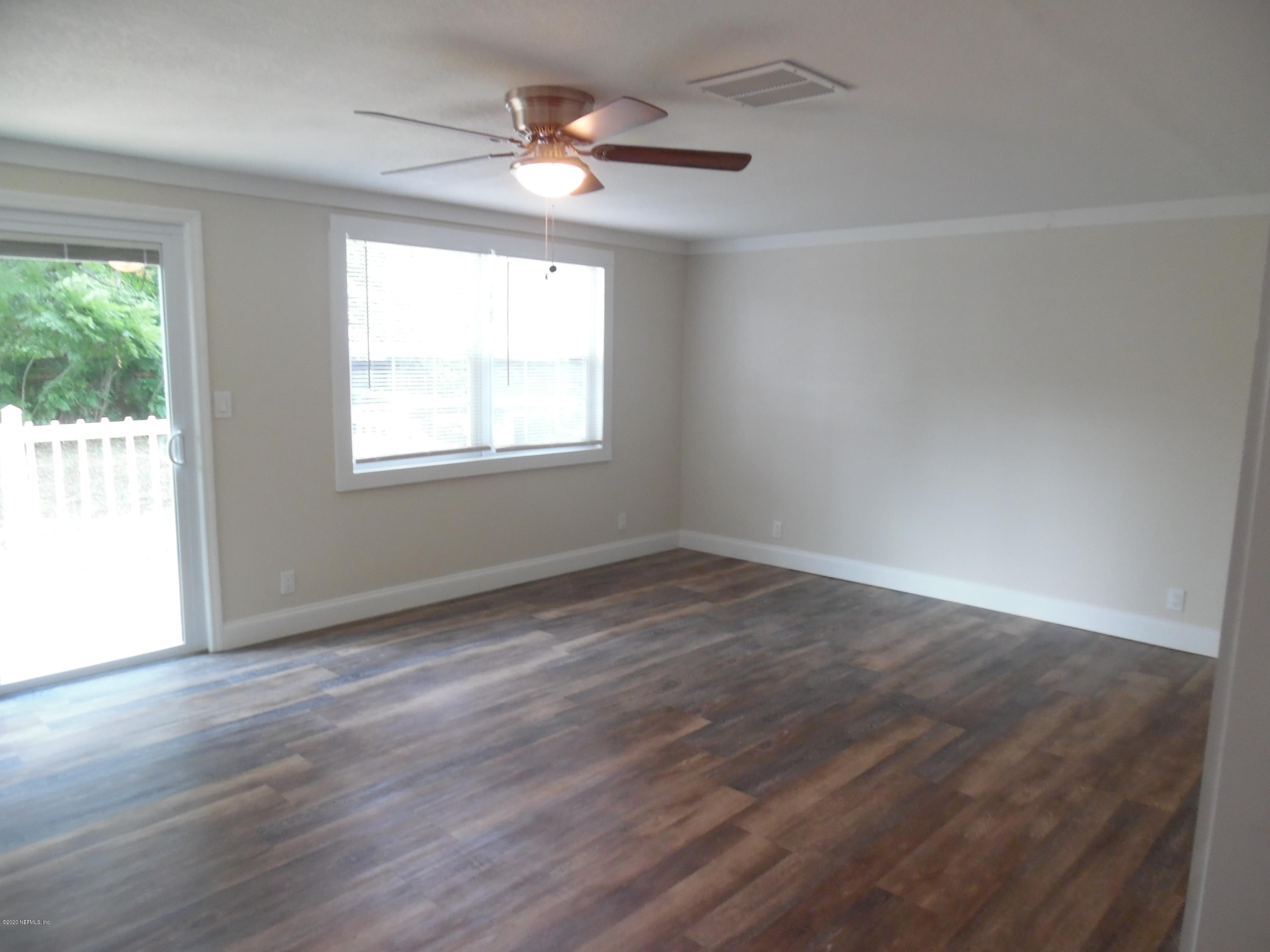 620 Southwest Field Avenue Keystone Heights, FL 32656 - Photo 48 of 68 an empty room with wooden floor and windows