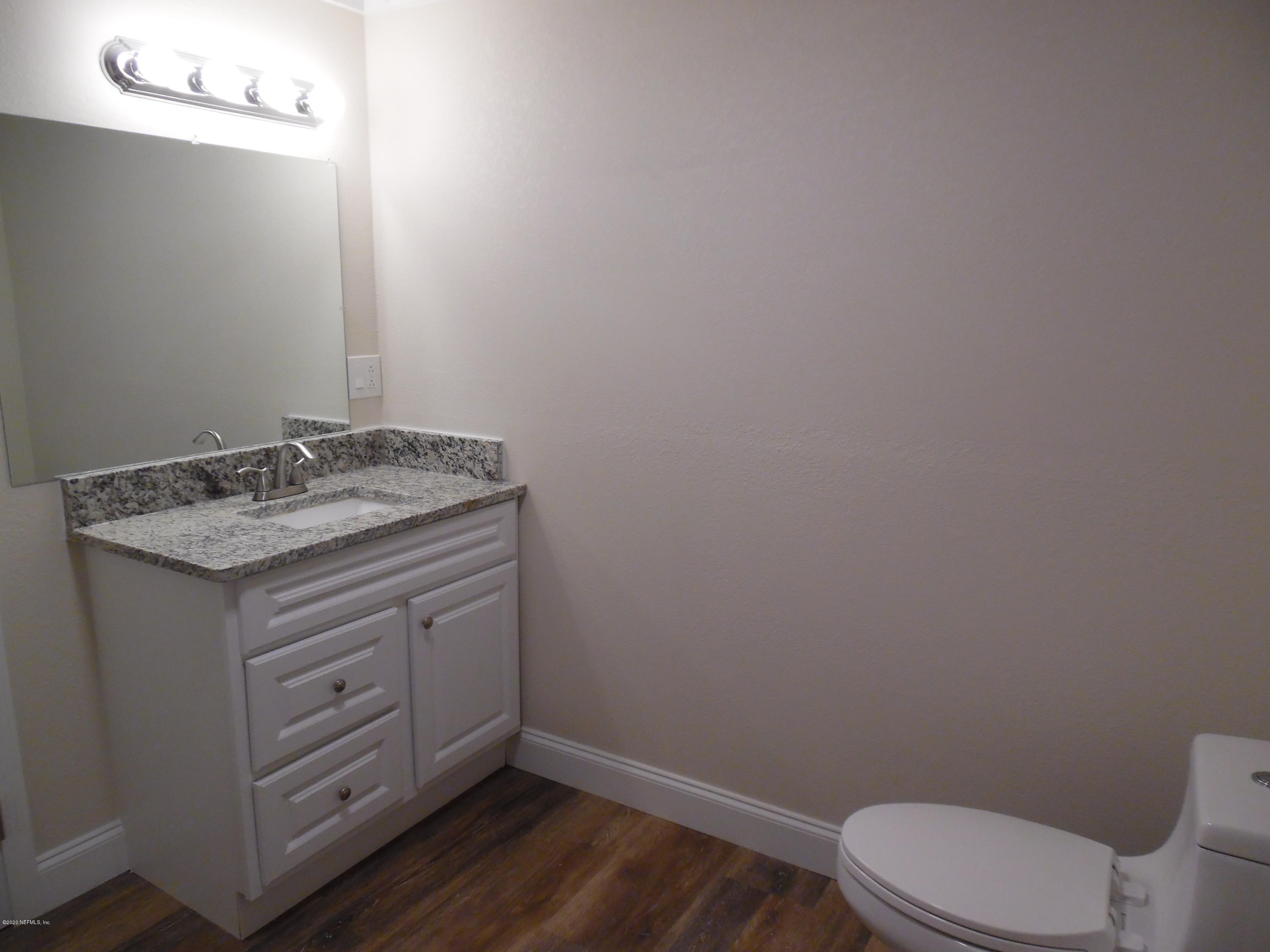 620 Southwest Field Avenue Keystone Heights, FL 32656 - Photo 51 of 68 a bathroom with a granite countertop toilet and a sink