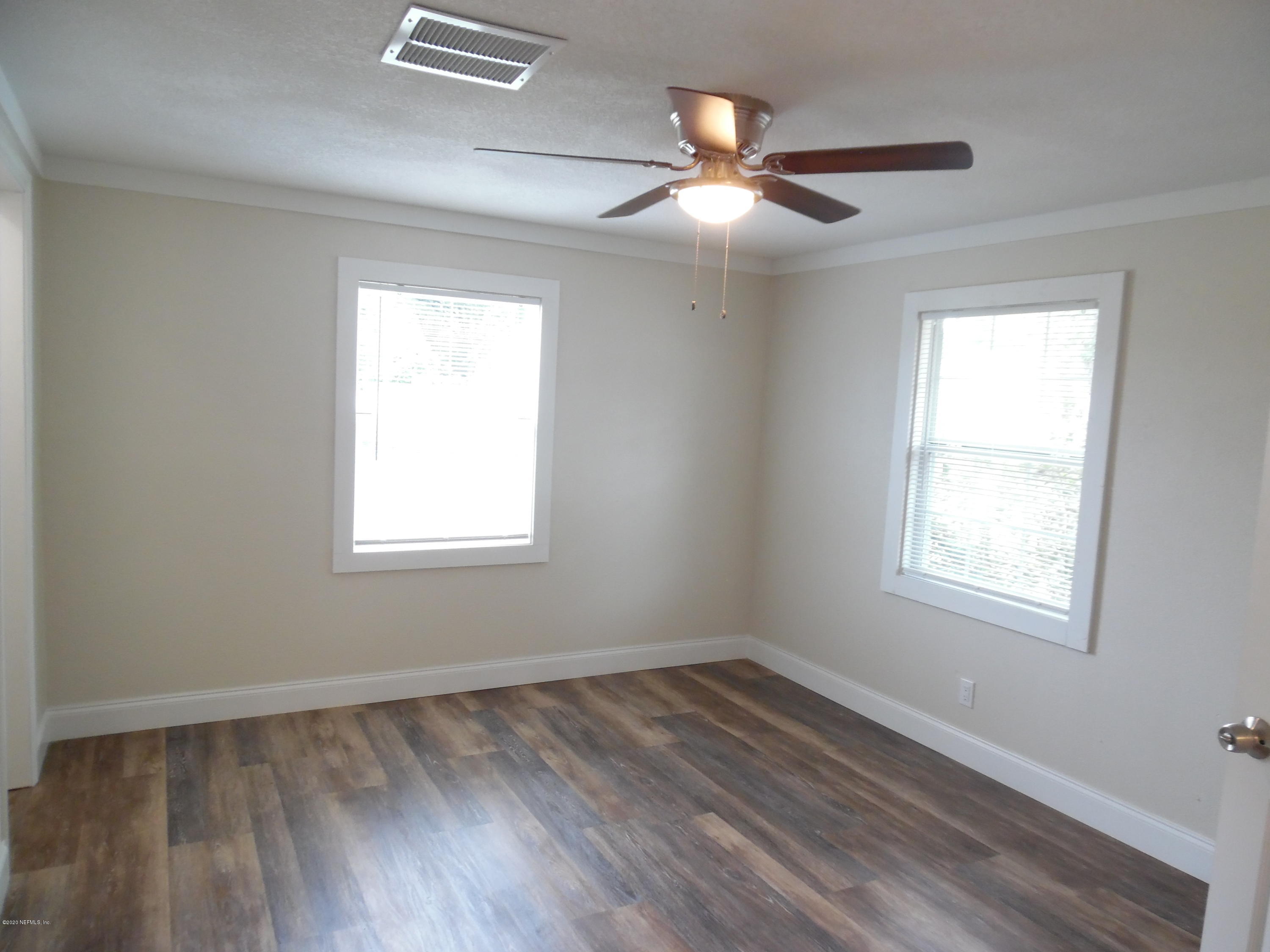 620 Southwest Field Avenue Keystone Heights, FL 32656 - Photo 56 of 68 a view of an empty room with wooden floor and a window
