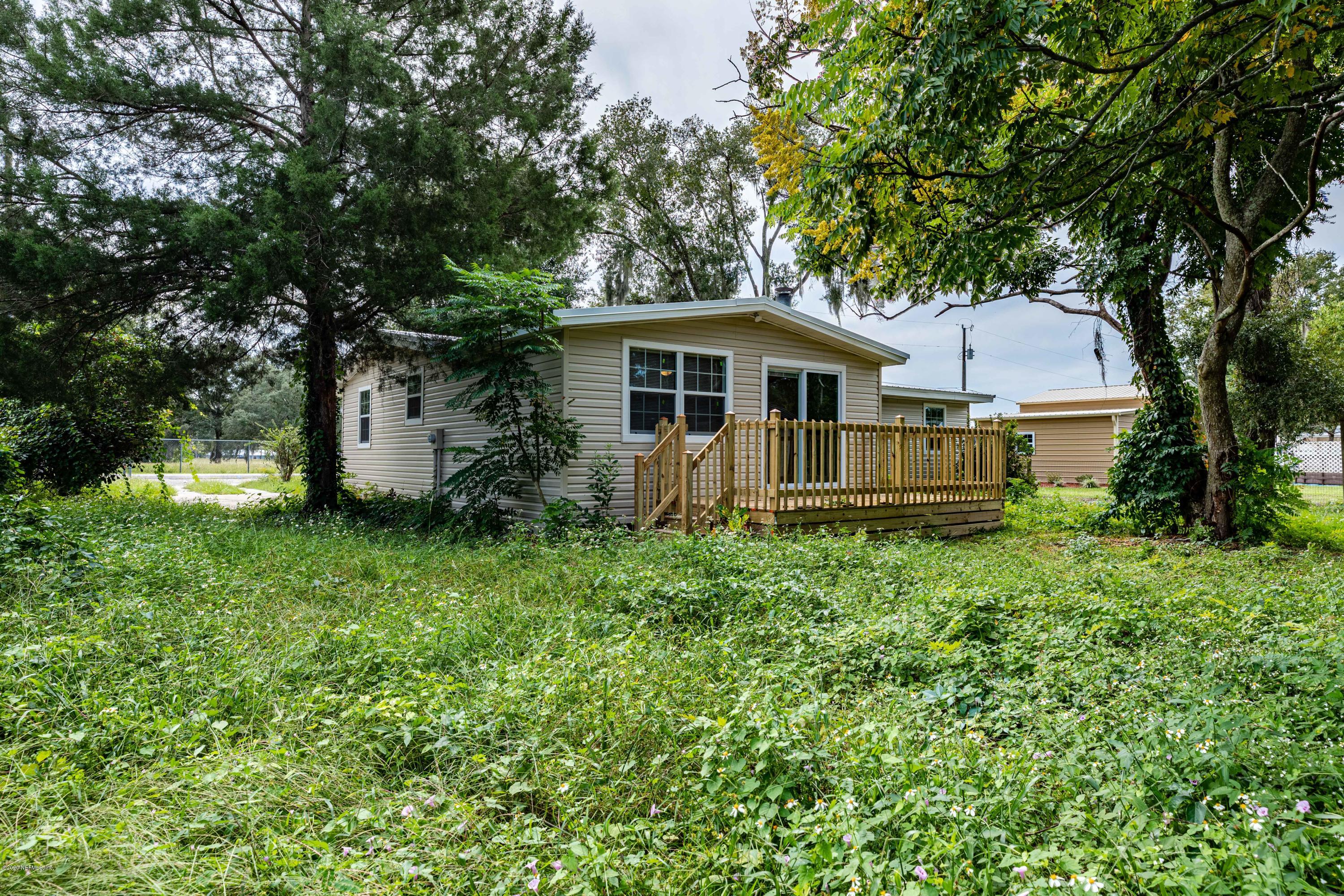 620 Southwest Field Avenue Keystone Heights, FL 32656 - Photo 65 of 68 a view of a house with a big yard and large trees