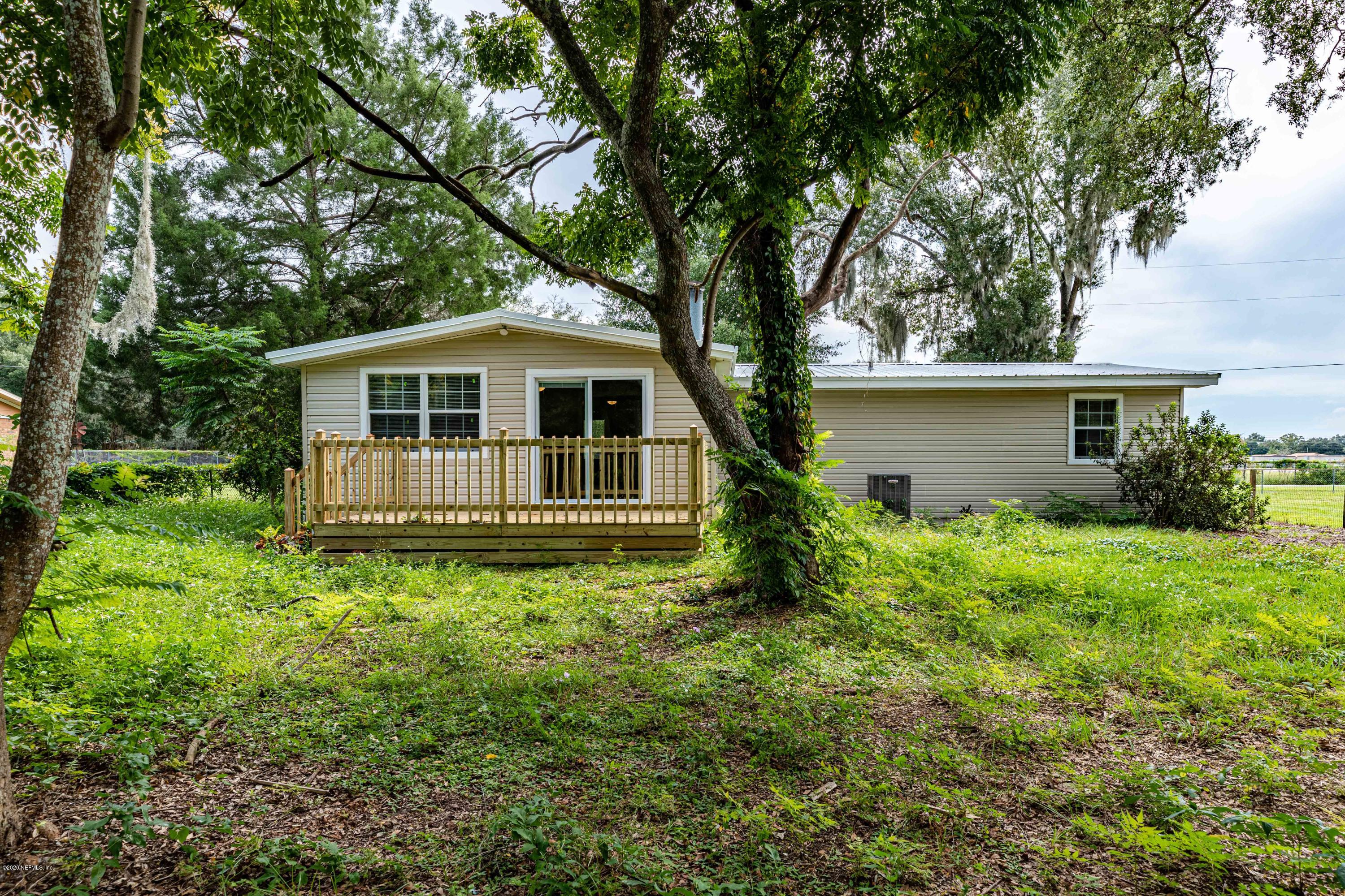 620 Southwest Field Avenue Keystone Heights, FL 32656 - Photo 66 of 68 a backyard of a house with plants and large tree