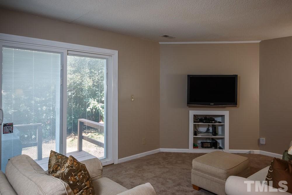 627 Bashford Road Raleigh, NC 27606 - Photo 8 of 25 Mounted TV comes with the house! New carpet and sliding door was replaced in 2011.