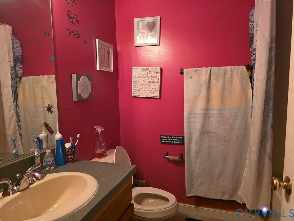 3161 Dorrell Road Aylett, VA 23009 - Photo 10 of 41 a bathroom with a sink a toilet and shower curtain