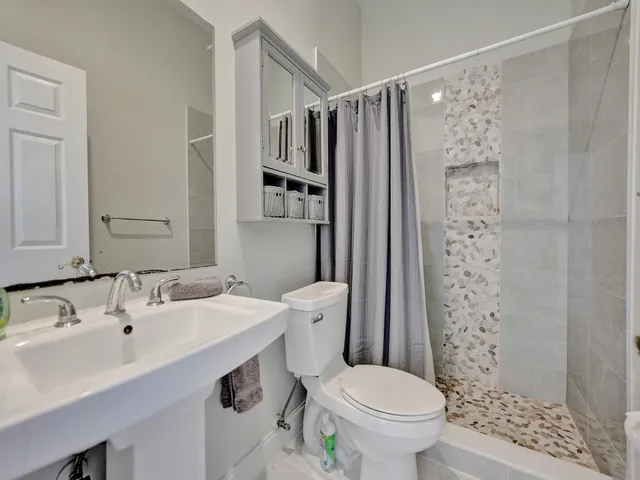 a bathroom with a sink toilet and shower