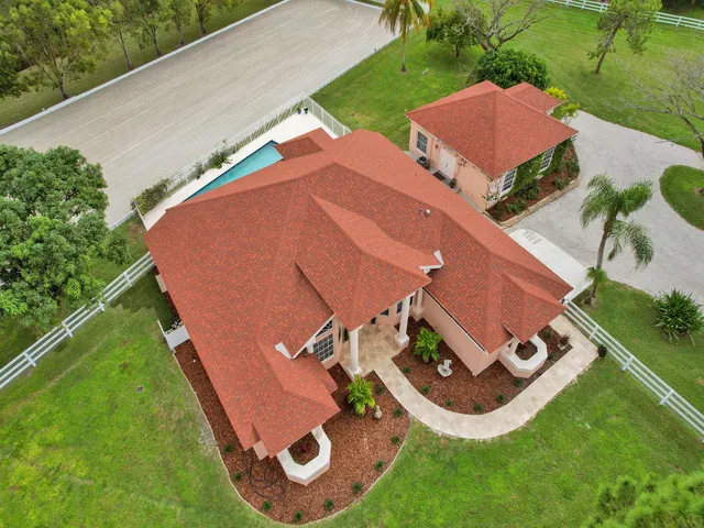 an aerial view of a house with garden space and street view
