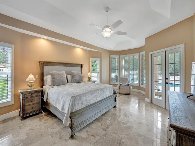 a bedroom with a large bed and a chandelier