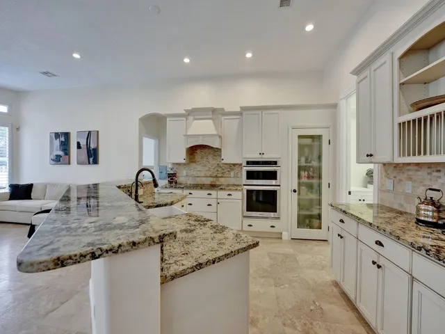 a kitchen with stainless steel appliances granite countertop a sink stove and cabinets