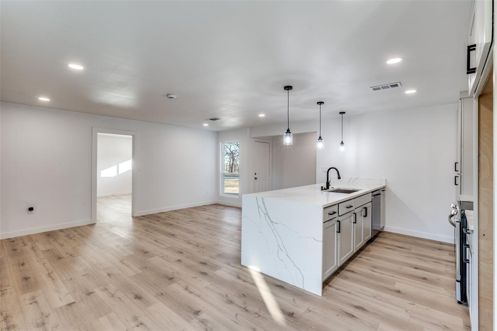 116 Cooper Drive Hurst, TX 76053 - Photo 11 of 25 a large white kitchen with a large stove a sink and a refrigerator
