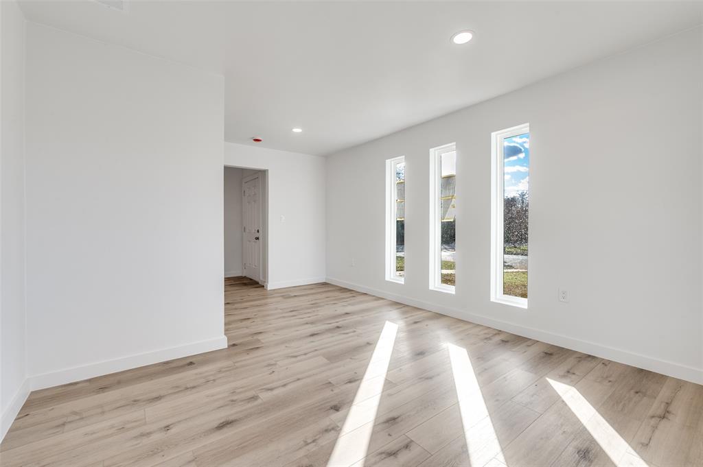 116 Cooper Drive Hurst, TX 76053 - Photo 13 of 25 a view of an empty room with wooden floor and a window