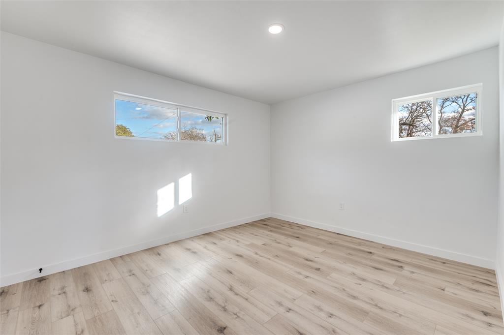 116 Cooper Drive Hurst, TX 76053 - Photo 15 of 25 an empty room with wooden floor and windows