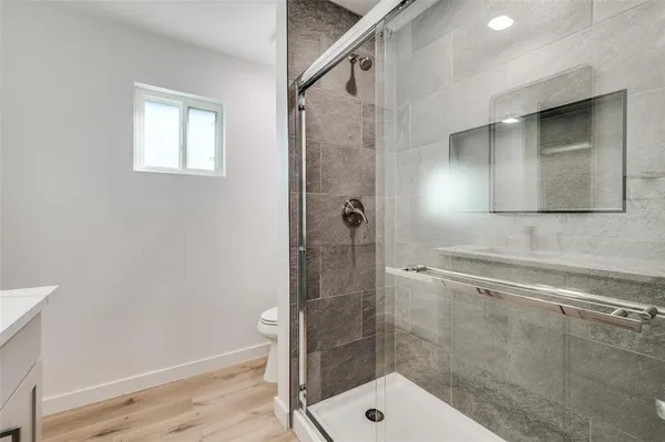 a bathroom with a shower and a sink