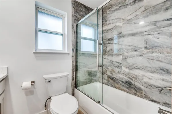 a bathroom with a toilet and a shower