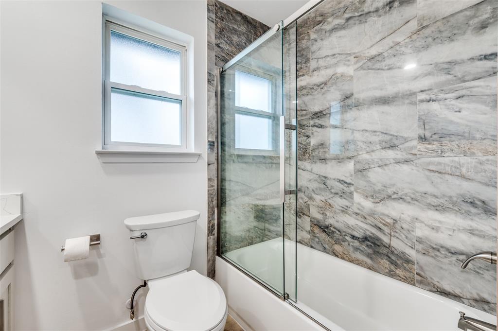 116 Cooper Drive Hurst, TX 76053 - Photo 21 of 25 a bathroom with a toilet and a shower