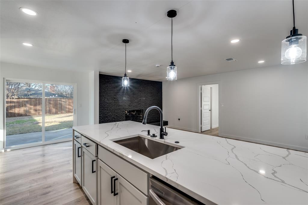 116 Cooper Drive Hurst, TX 76053 - Photo 7 of 25 a kitchen with a sink a counter space and a view of living room