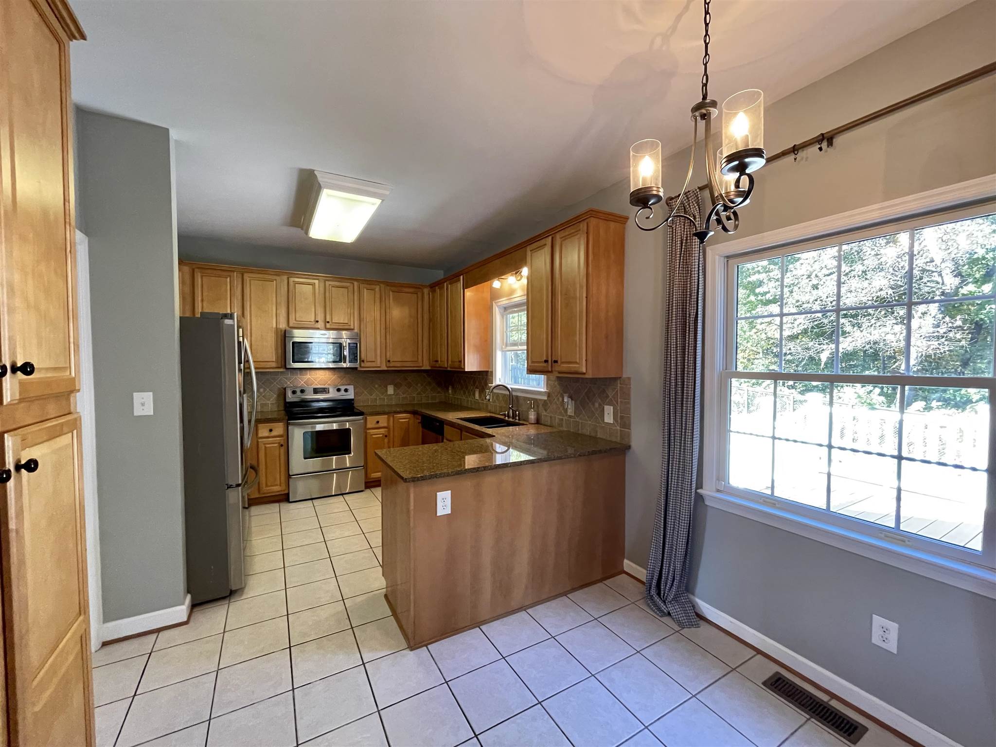 109 Long Bow Road Waynesboro, VA 22980 - Photo 11 of 42 a kitchen with stainless steel appliances granite countertop a refrigerator and a sink