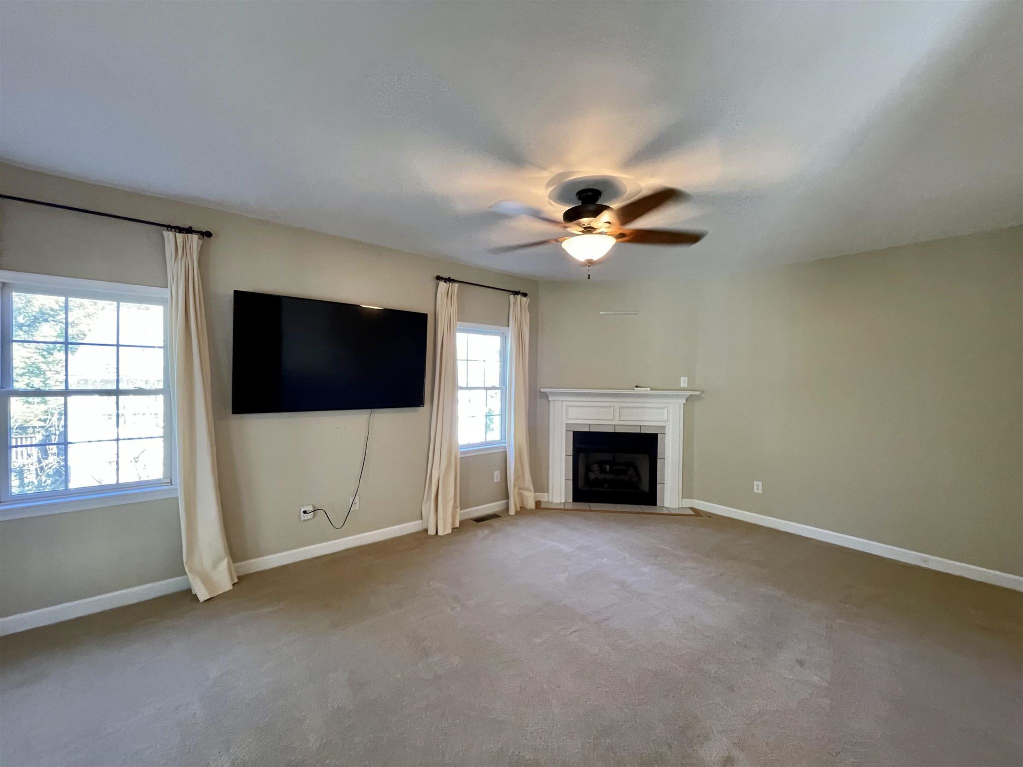 109 Long Bow Road Waynesboro, VA 22980 - Photo 14 of 42 an empty room with windows fireplace and fan