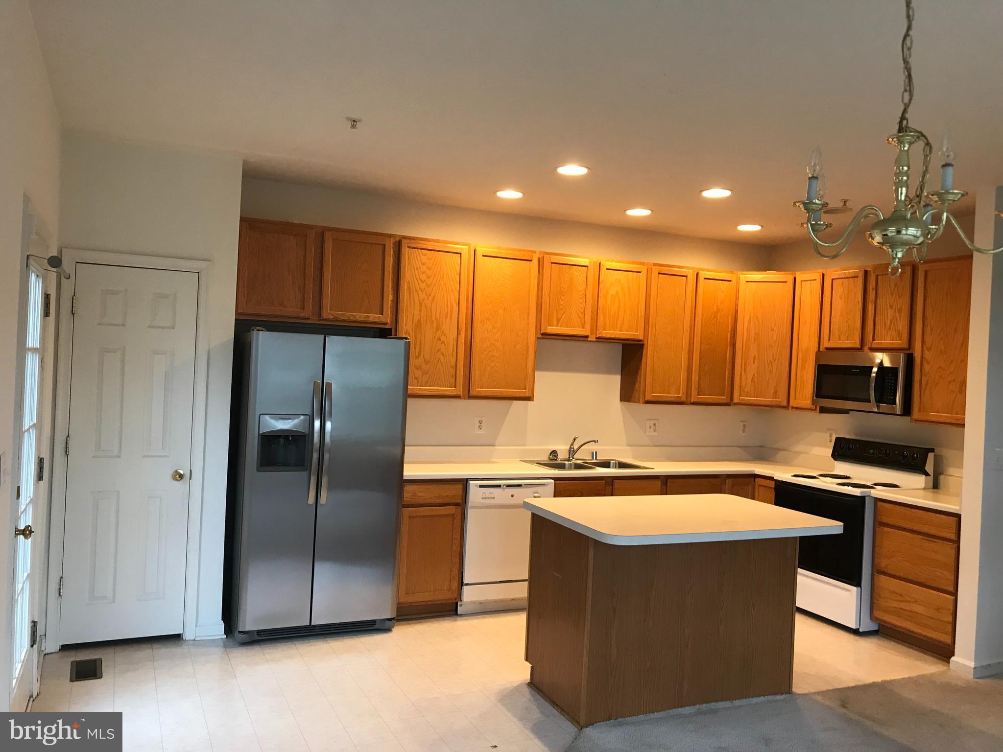 5061 Leasdale Road Rosedale, MD 21237 - Photo 3 of 6 Kitchen with island and access to deck
