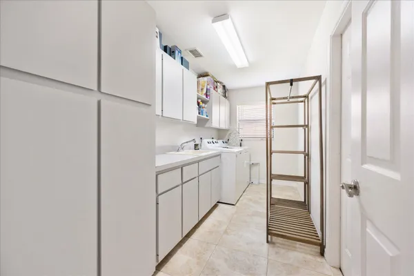 a workspace with chandelier and a window