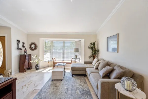 a view of a dining room with furniture a chandelier and wooden floor
