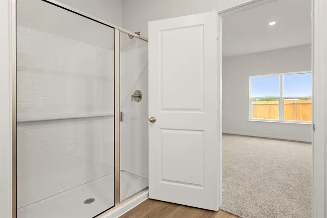 a bathroom with a glass shower door