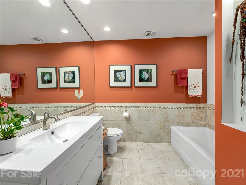 22 Sunset Summit Asheville, NC 28804 - Photo 29 of 42 a bathroom with a bathtub sink mirror and toilet