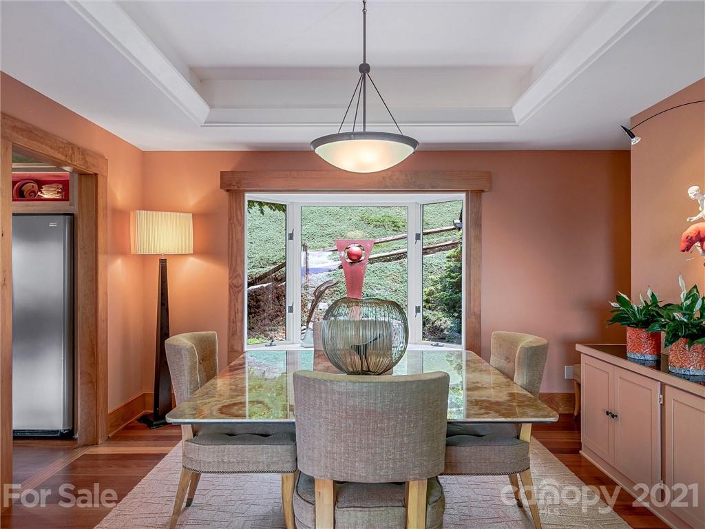 22 Sunset Summit Asheville, NC 28804 - Photo 9 of 42 a view of a dining room with furniture wooden floor and chandelier