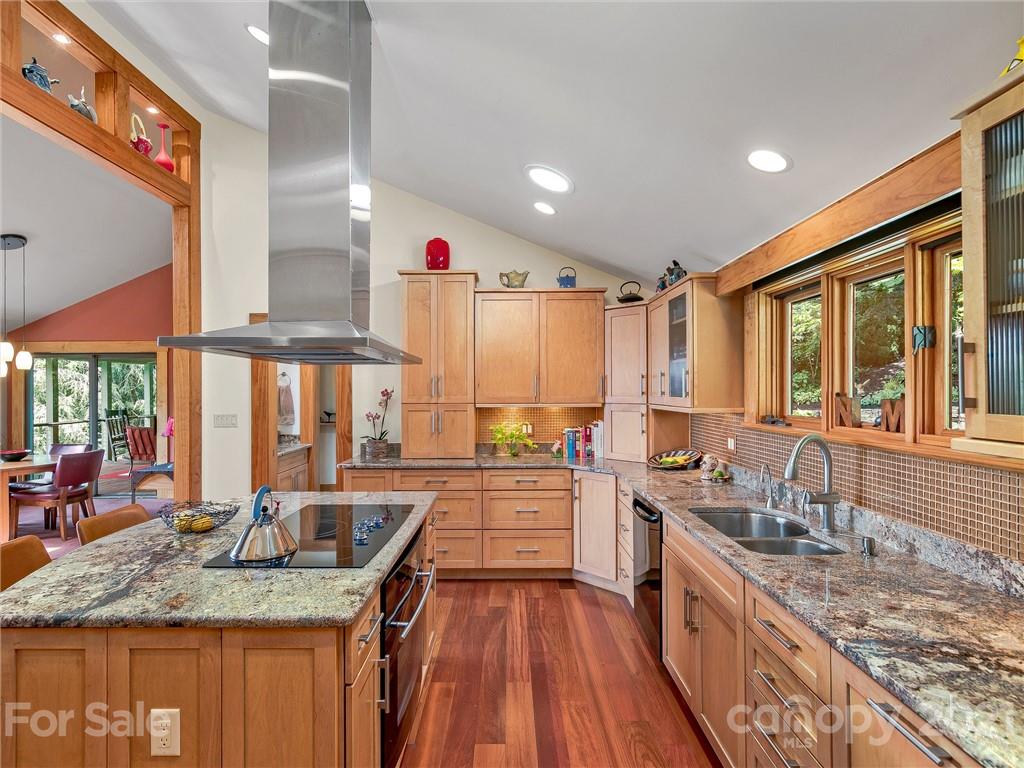 22 Sunset Summit Asheville, NC 28804 - Photo 10 of 42 a kitchen with stainless steel appliances granite countertop a sink a stove and a wooden cabinets