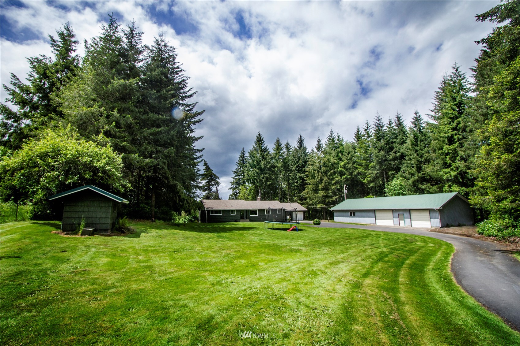 685 Bond Road Castle Rock, WA 98611 - Photo 1 of 37 a view of garden with trees in the background
