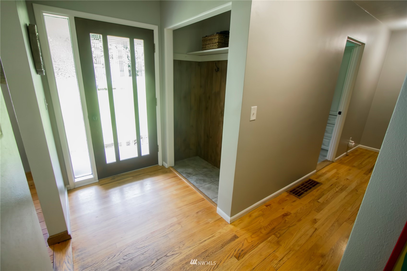 685 Bond Road Castle Rock, WA 98611 - Photo 3 of 37 a view of an empty room with wooden floor and a window