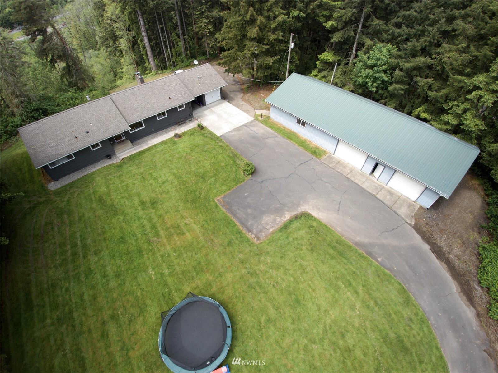 685 Bond Road Castle Rock, WA 98611 - Photo 36 of 37 an aerial view of a house with a yard and trees