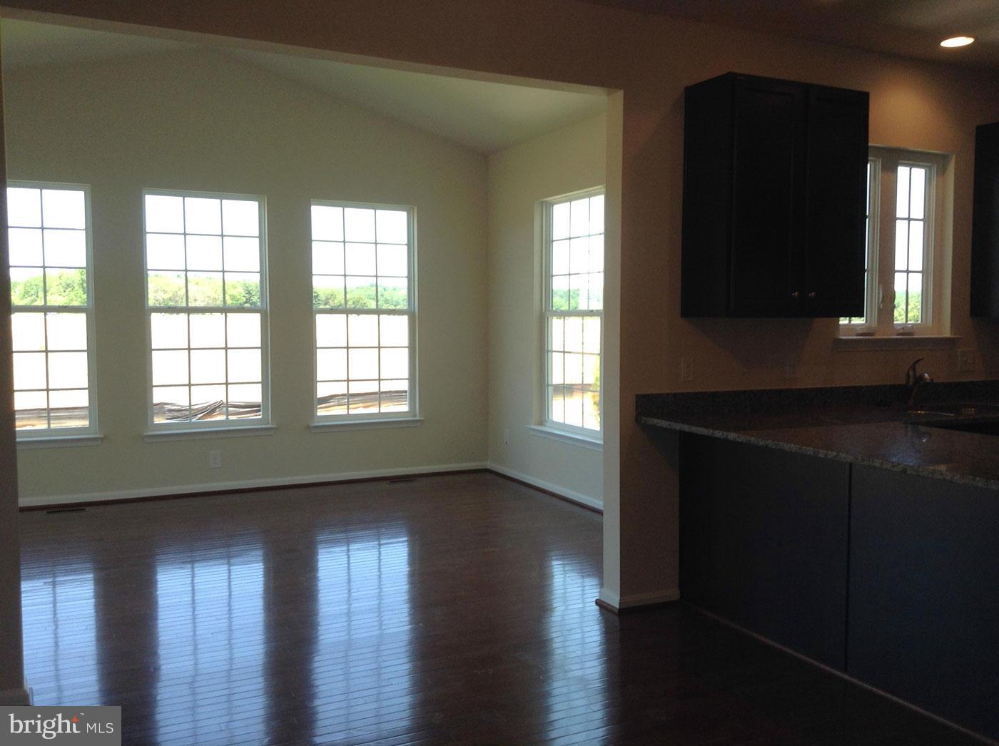 5279 Longbow Road King George, VA 22485 - Photo 14 of 30 a view of an empty room with wooden floor and a window