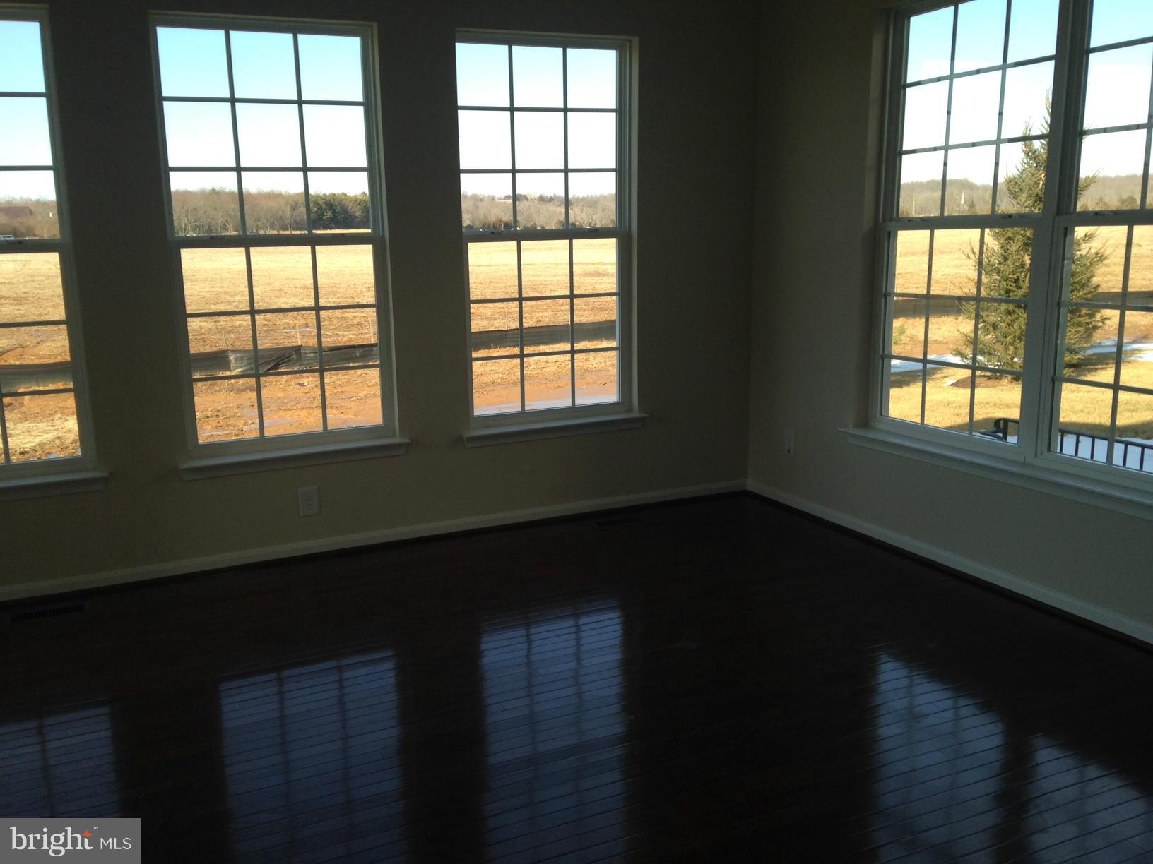 5279 Longbow Road King George, VA 22485 - Photo 19 of 30 a view of an empty room with wooden floor and a window