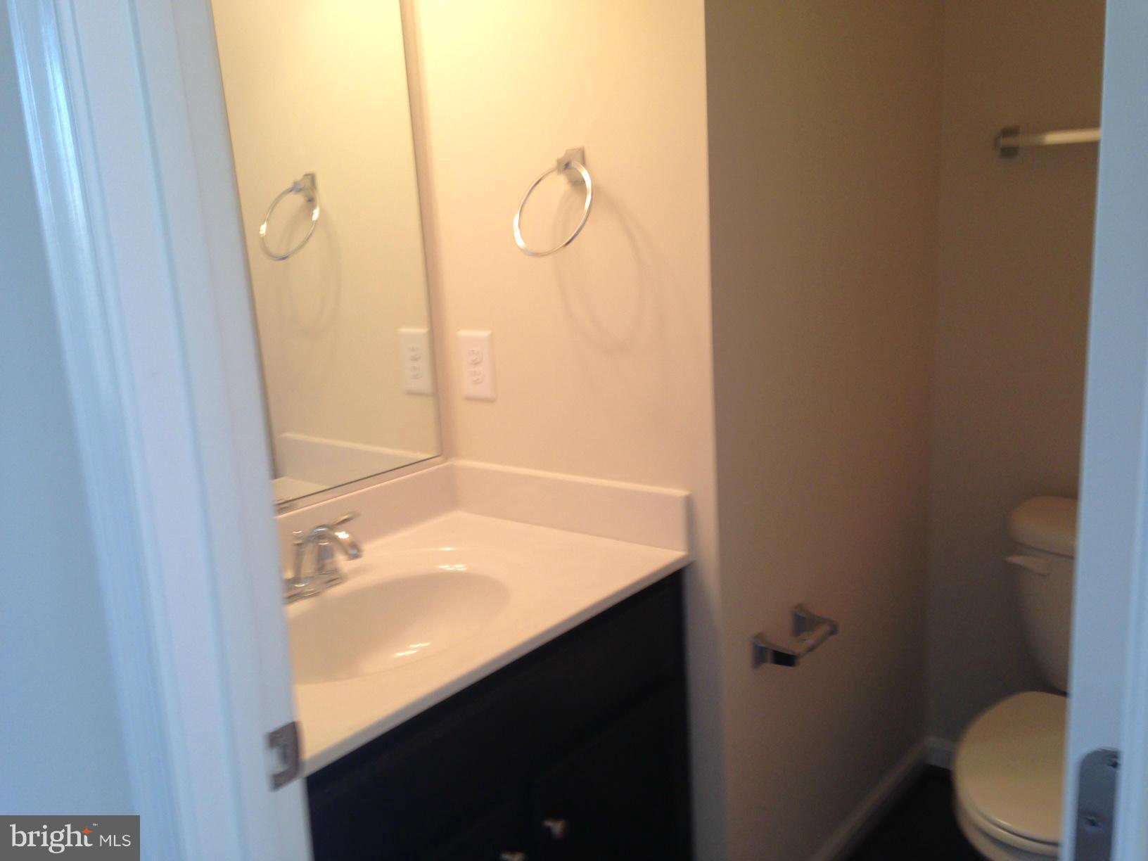 5279 Longbow Road King George, VA 22485 - Photo 25 of 30 a bathroom with a granite countertop sink toilet and shower